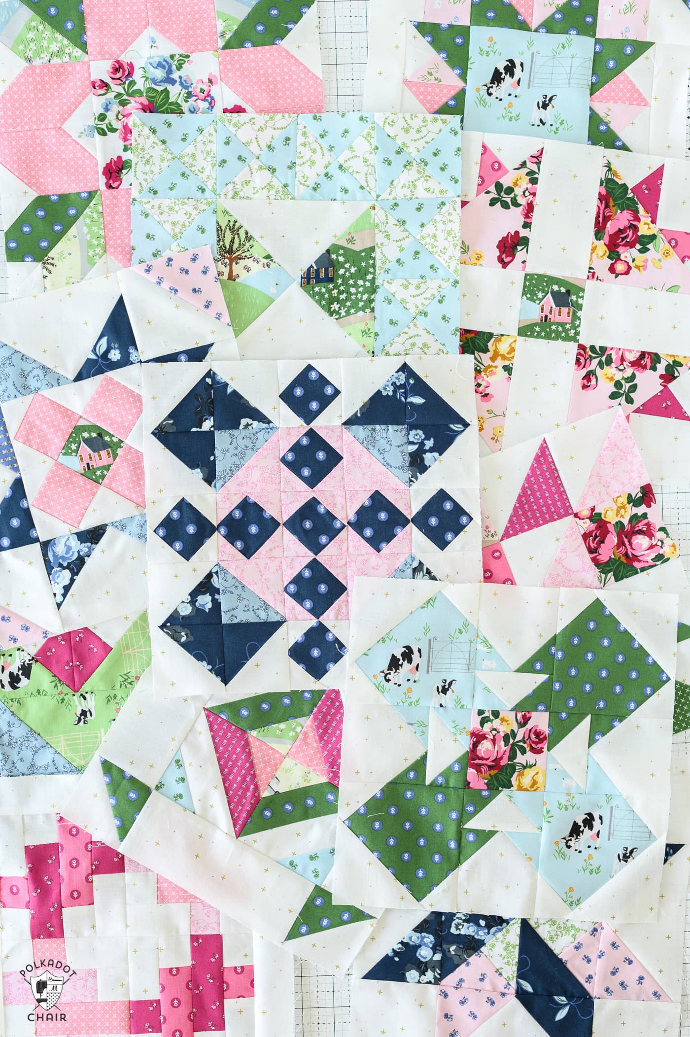 several colorful quilt blocks scattered on white table