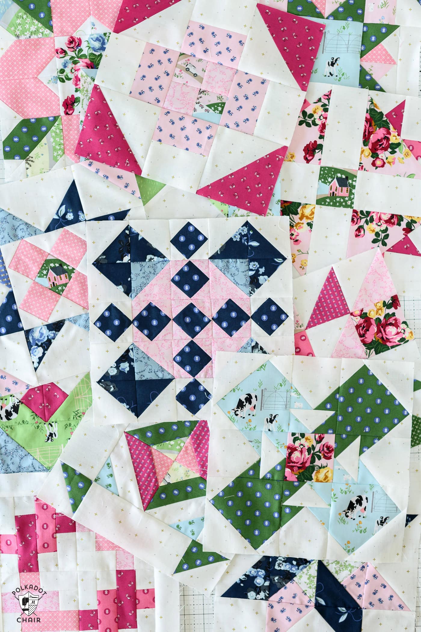 several colorful quilt blocks scattered on white table