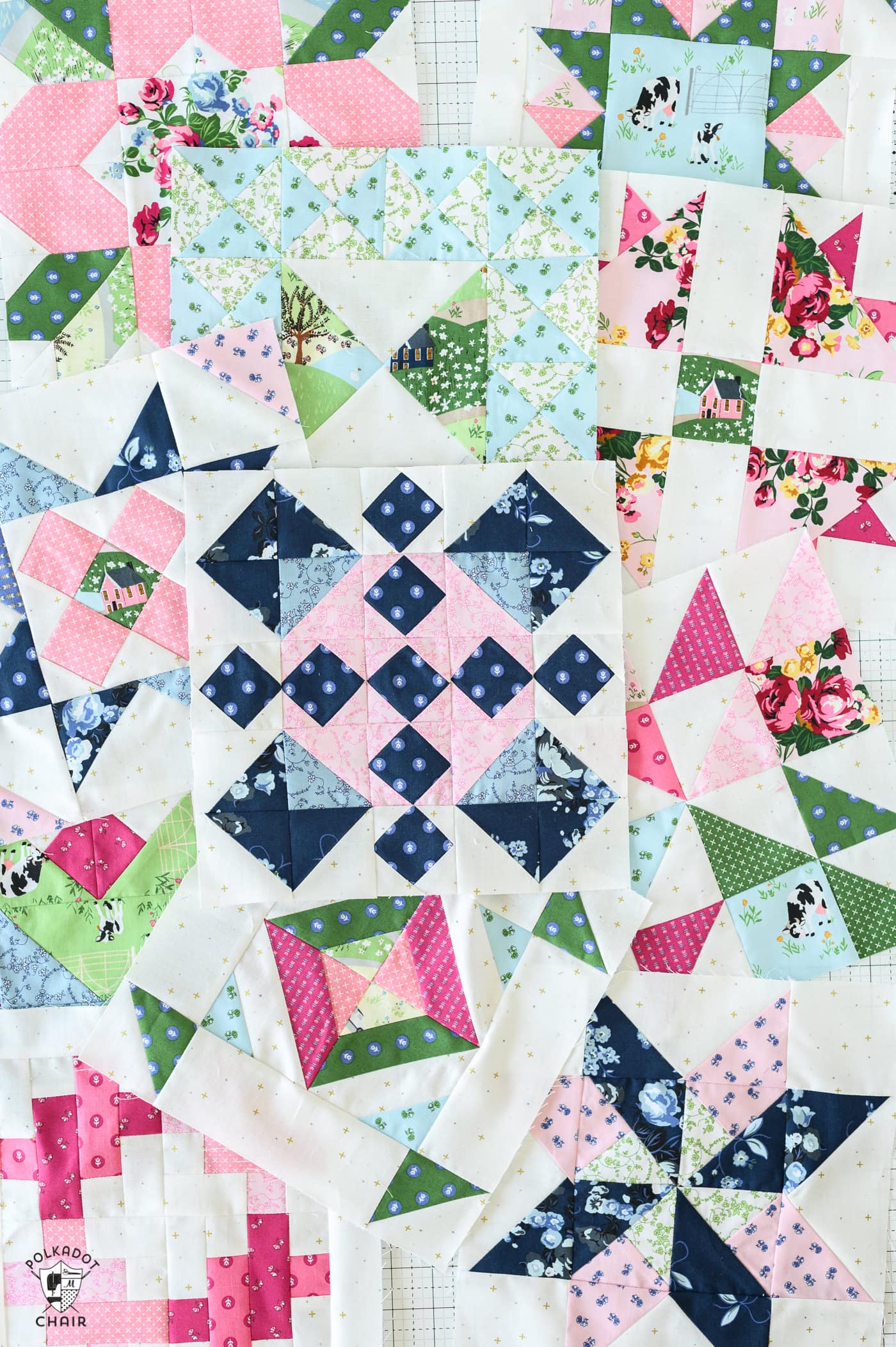 several colorful quilt blocks scattered on white table
