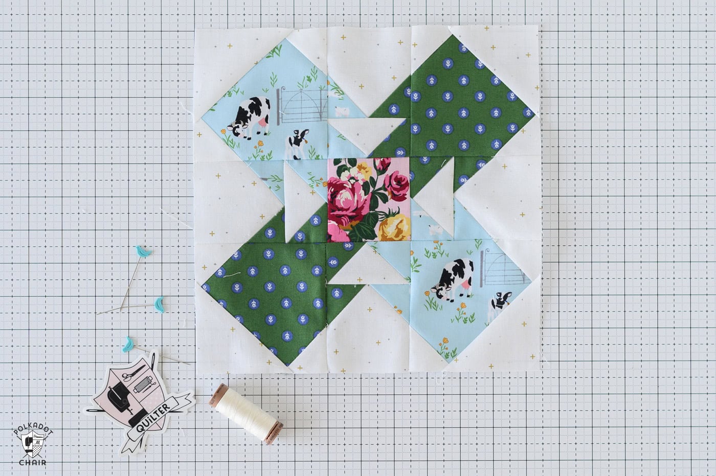 green and blue quilt block on white cutting mat