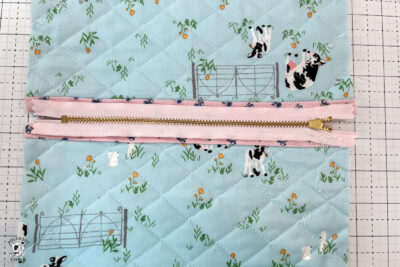 pink bag during construction process on white cutting mat with zipper