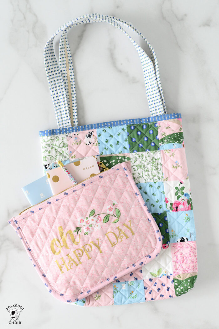 pink quilted zip pouch on white marble table with patchwork quilted bag