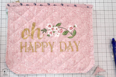 pink bag during construction process on white cutting mat with zipper