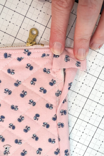 pink bag during construction process on white cutting mat with zipper