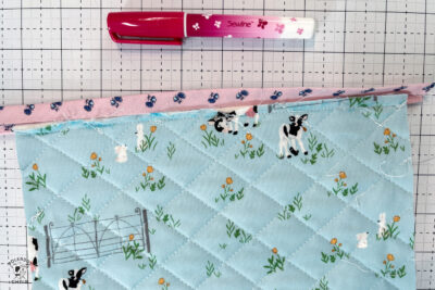 pink bag during construction process on white cutting mat