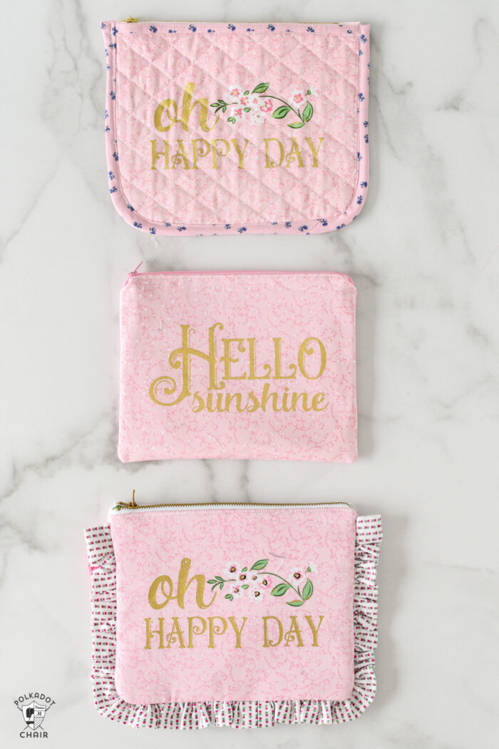 pink and blue zip pouches on white table