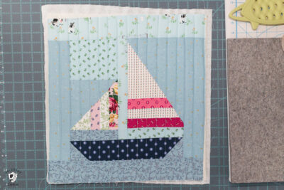 quilt block, foam and fabric on white cutting mat