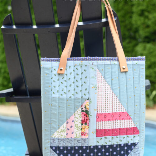 quilted tote bag on navy chair next to pool