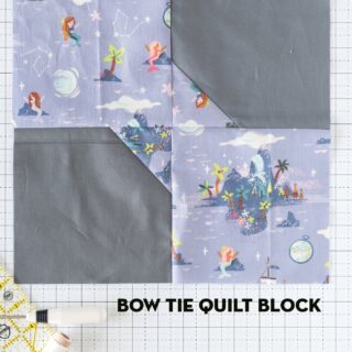 gray and purple quilt block on white cutting mat