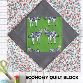 economy quilt block on white cutting mat with sewing notions