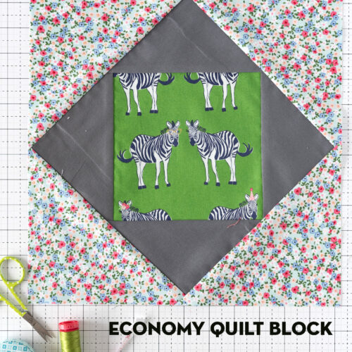 economy quilt block on white cutting mat with sewing notions
