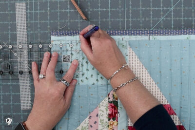 hand marking placement of handles on tote bag