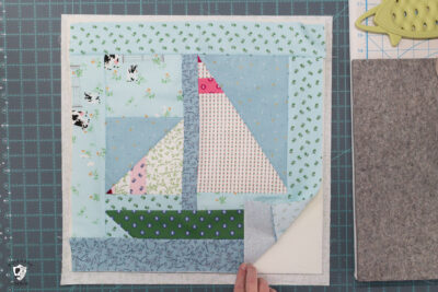 quilt block, foam and fabric on white cutting mat