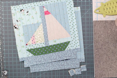 quilt block, foam and fabric on white cutting mat