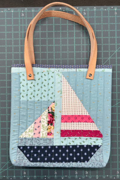 quilted tote bag on navy blue cutting mat
