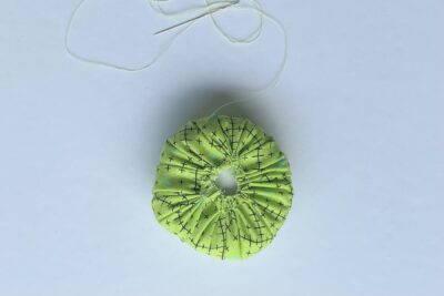 green circle fabric after being gathered with stuffing