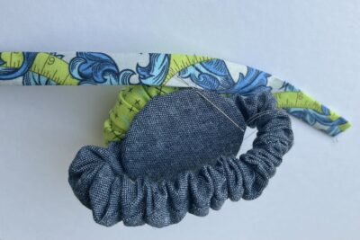 blue and green pincushion during construction steps