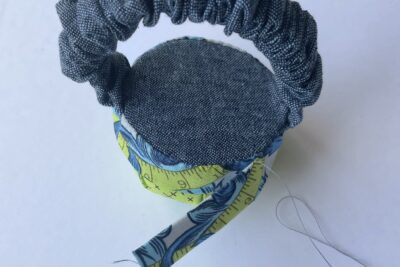 blue and green pincushion during construction steps
