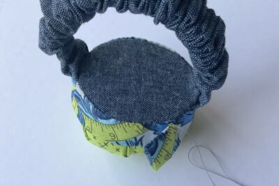 blue and green pincushion during construction steps