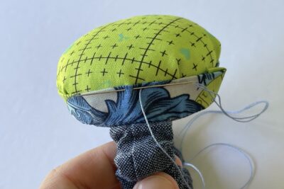 blue and green pincushion during construction steps