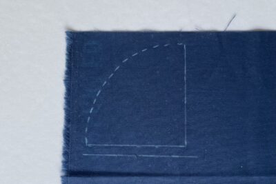 quarter circle sketched on blue fabric