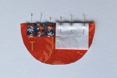 ribbon and felt pinned to half circle of fabric