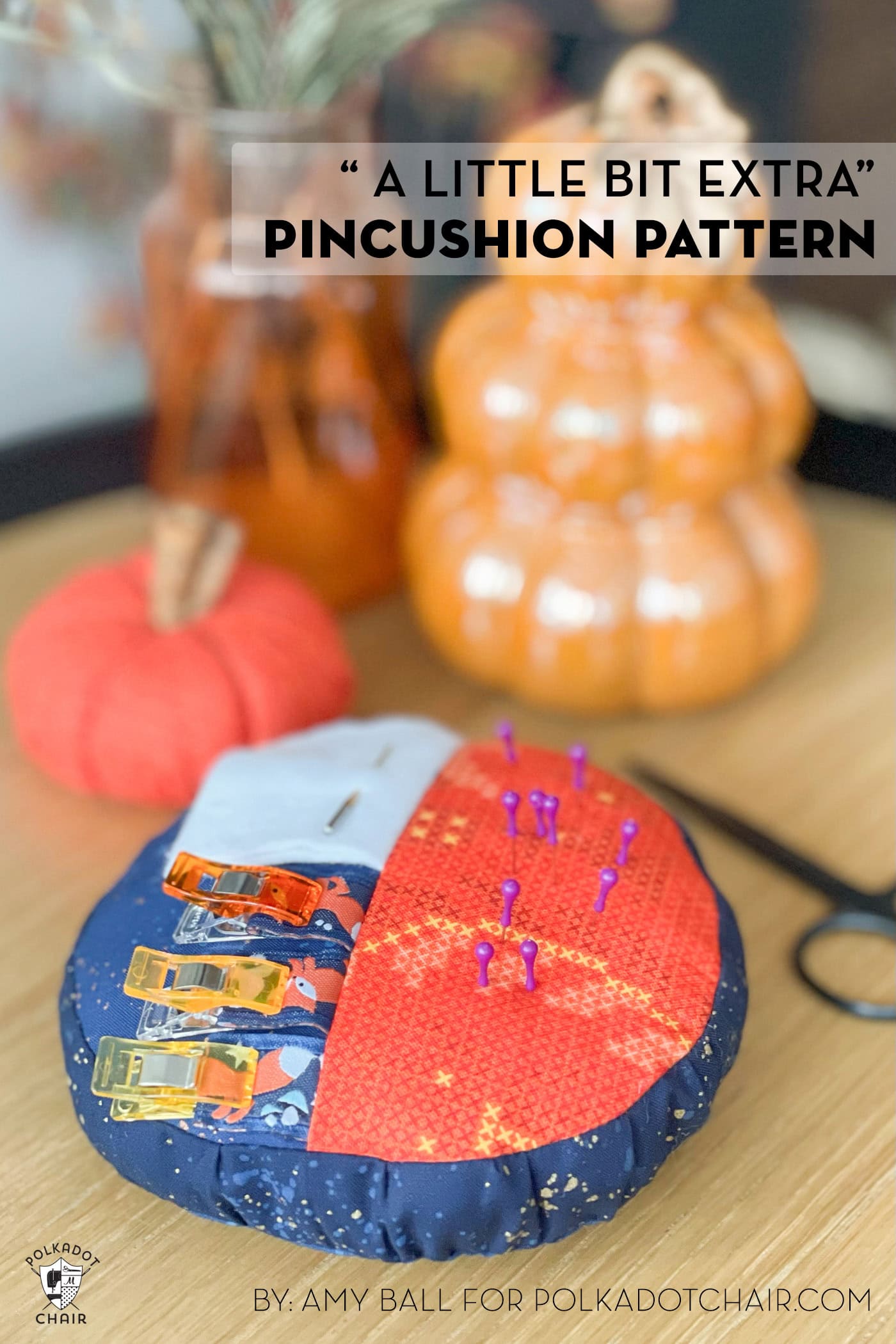 orange and blue round pincushion on wood table