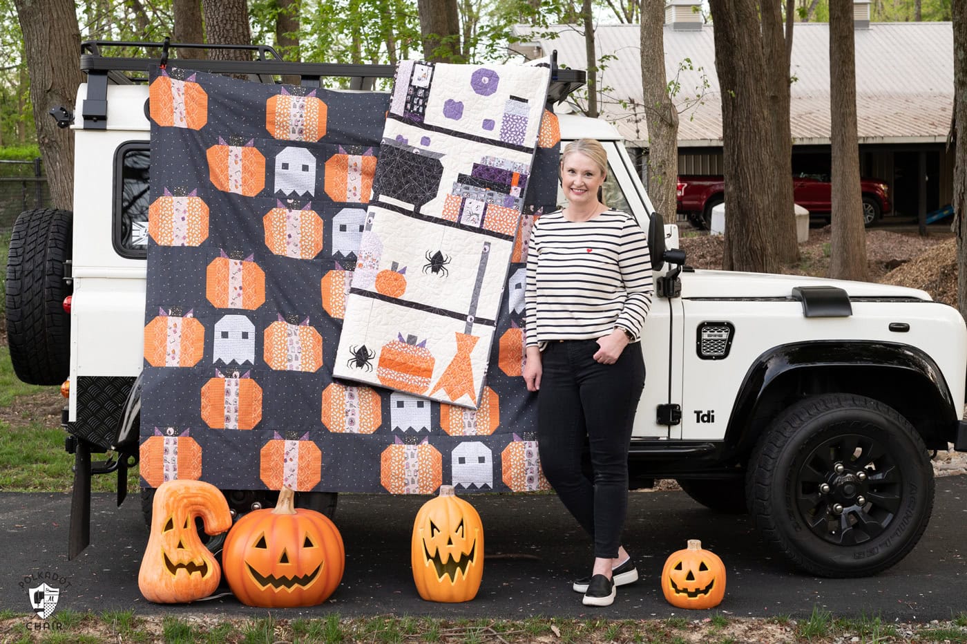 woman standing next to car gray quilt outdoors, pumpkin quilt with dark gray background and white ghosts quilt blocks