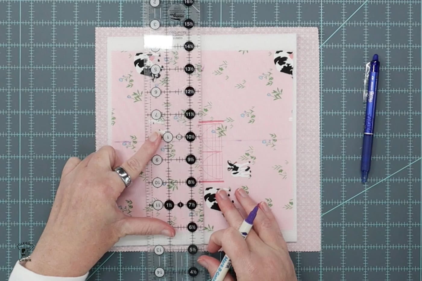 marking lines on pink fabric with ruler