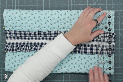 blue ruffle zip pouch in progress, pouch on blue cutting mat