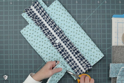 blue ruffle zip pouch in progress, pouch on blue cutting mat