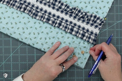 blue ruffle zip pouch in progress, pouch on blue cutting mat