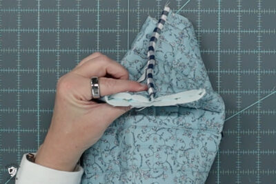 blue ruffle zip pouch in progress, pouch on blue cutting mat