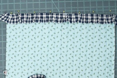 blue ruffle zip pouch in progress, pouch on blue cutting mat