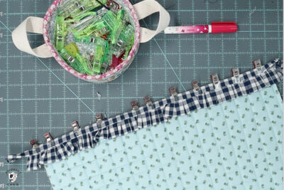 blue ruffle zip pouch in progress, pouch on blue cutting mat