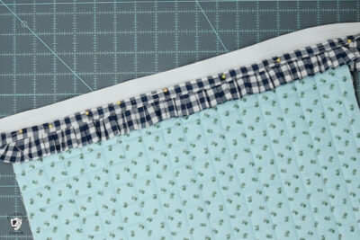 blue ruffle zip pouch in progress, pouch on blue cutting mat