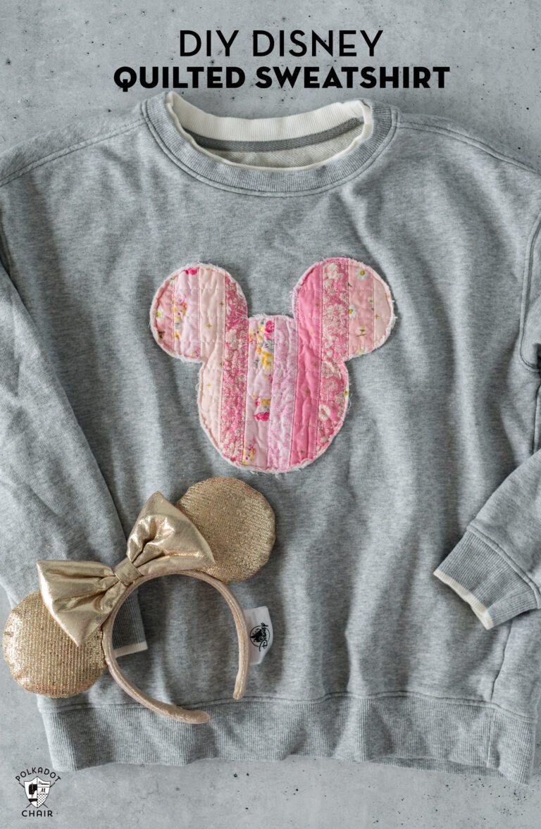 gray disney sweashirt on table with mickey ears