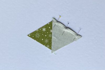 green fabric triangles on white table during construction process.