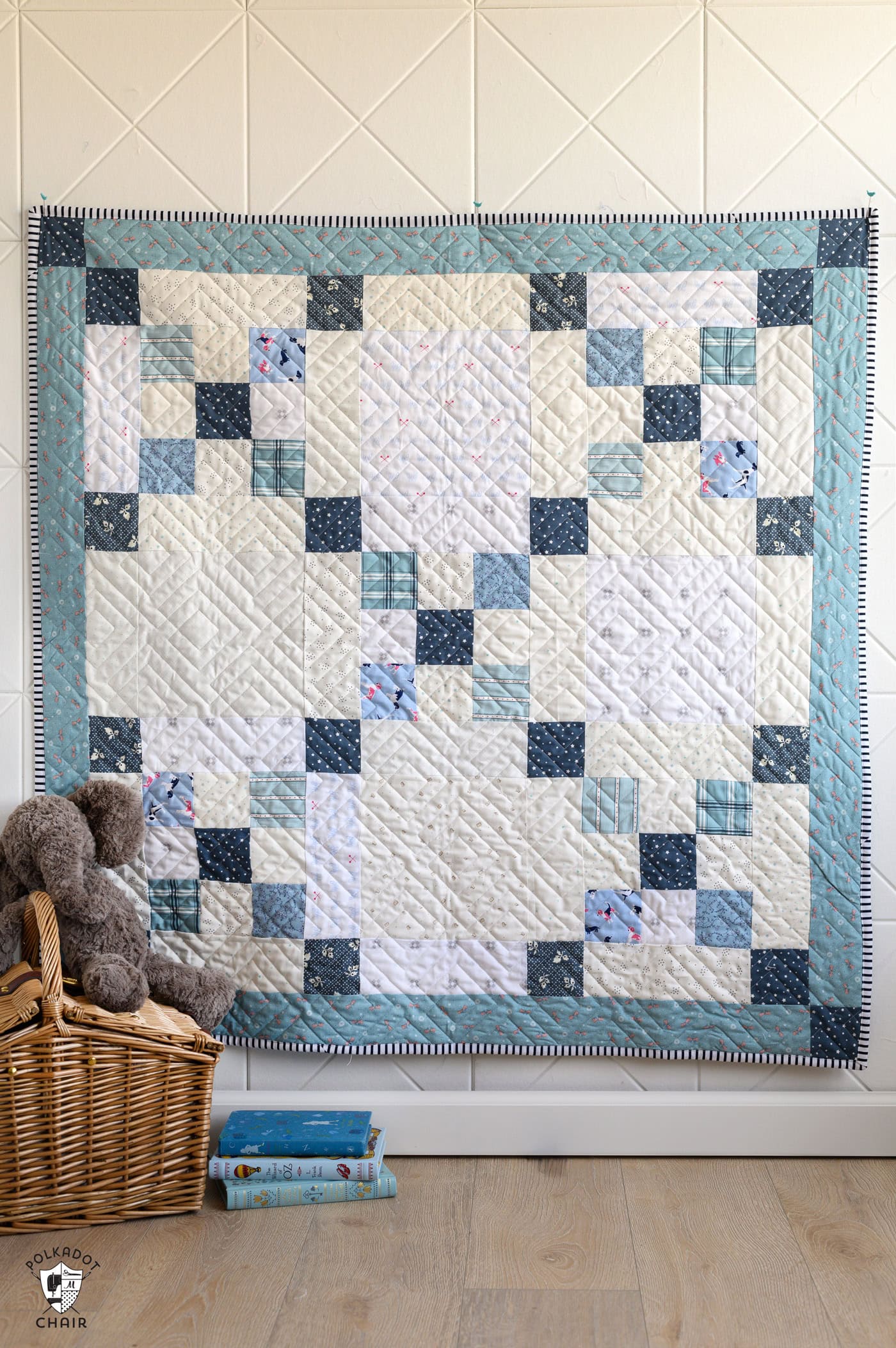 blue and ivory baby quilt on bed