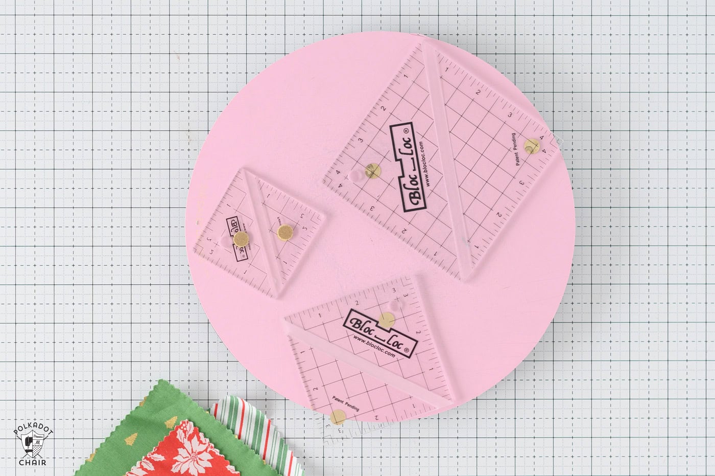 bloc loc rulers on pink cutting mat on table
