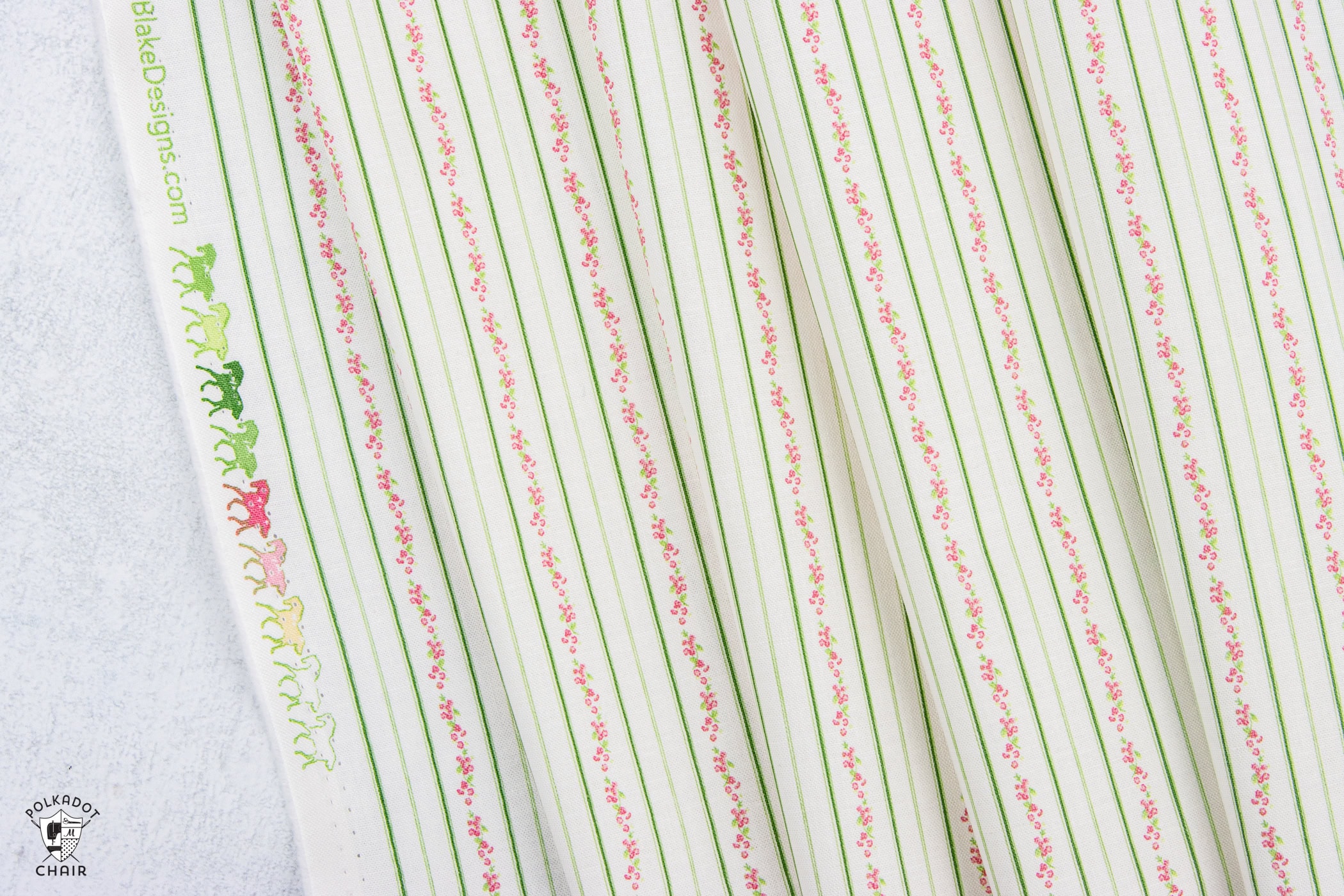 close up of cream fabric with green stripes