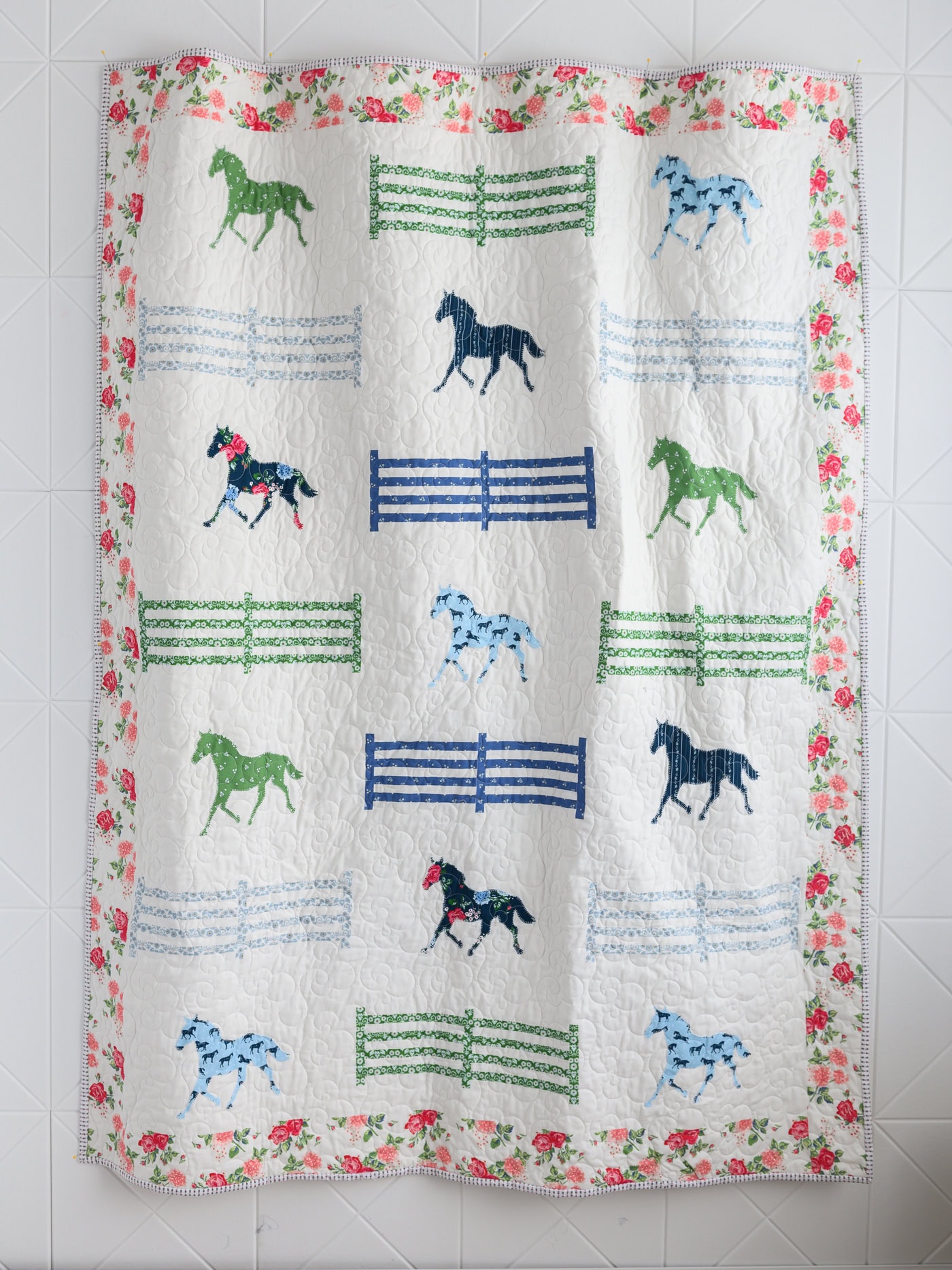 Quilt with horses and fence posts in blue and green