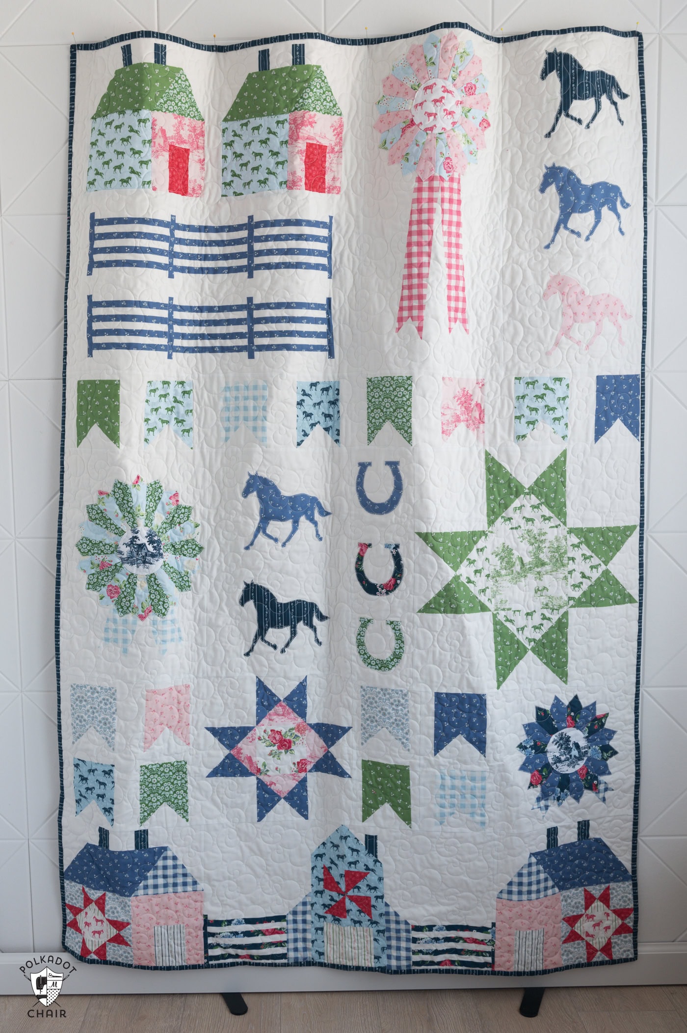Quilt with horses and fence posts in blue and green and pink