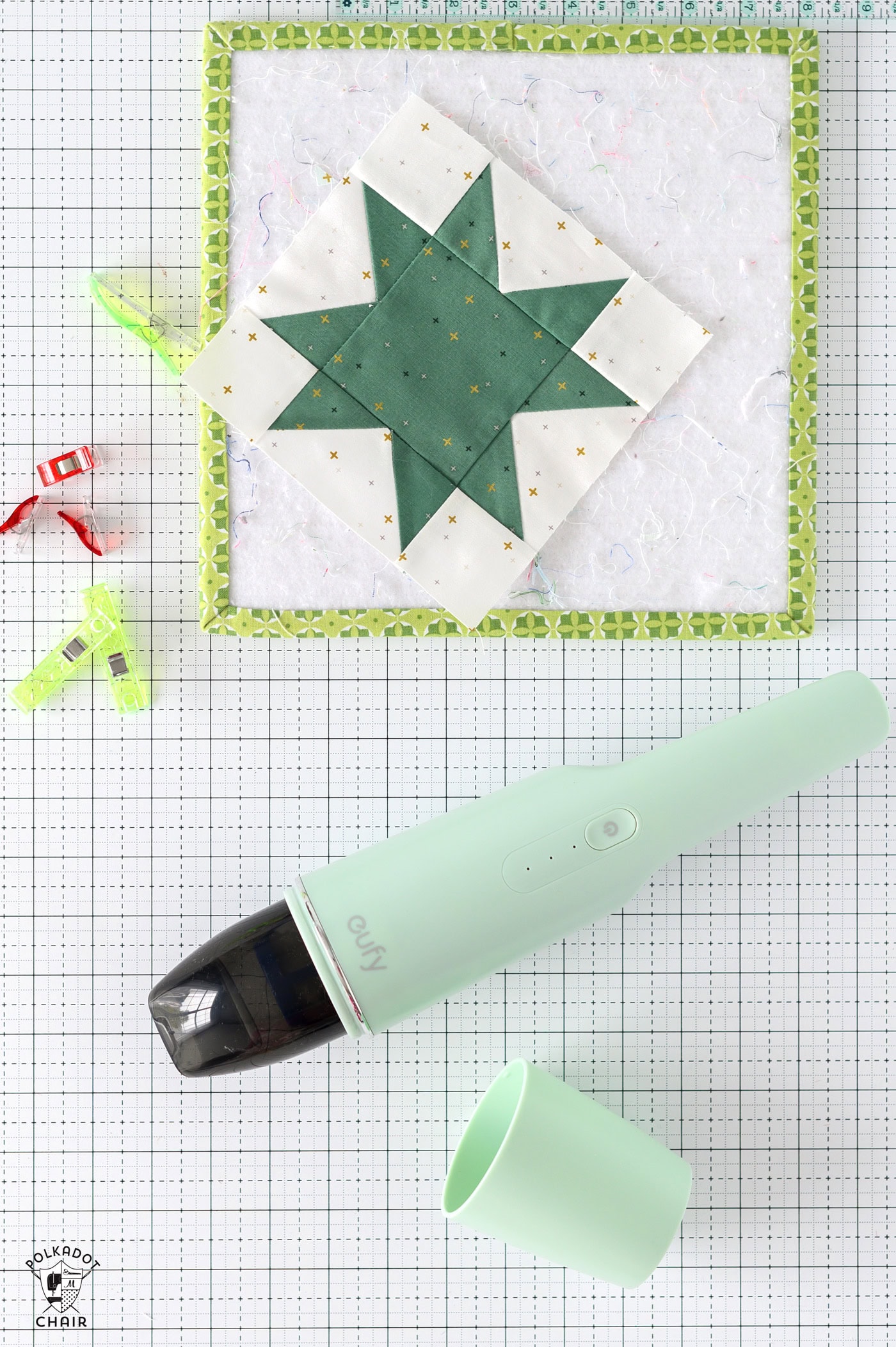 mint green hand held vaccum on white table