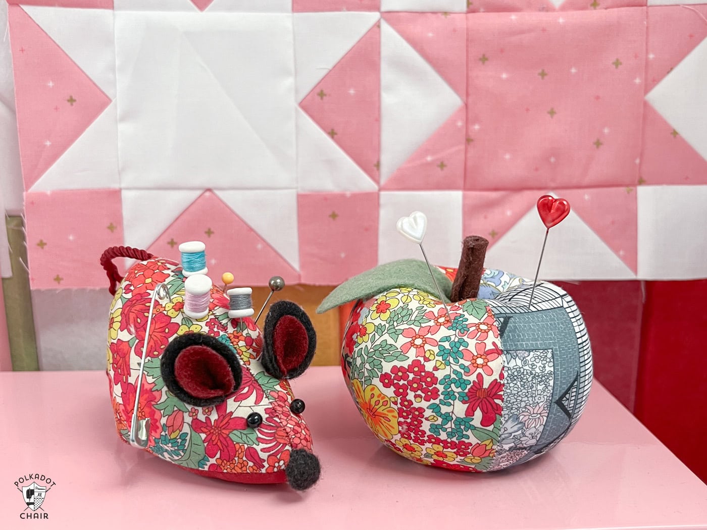 two pincushions on pink box