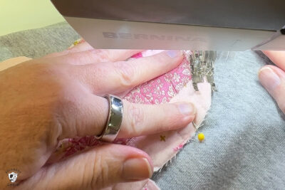 close up of sewing shape to sweatshirt