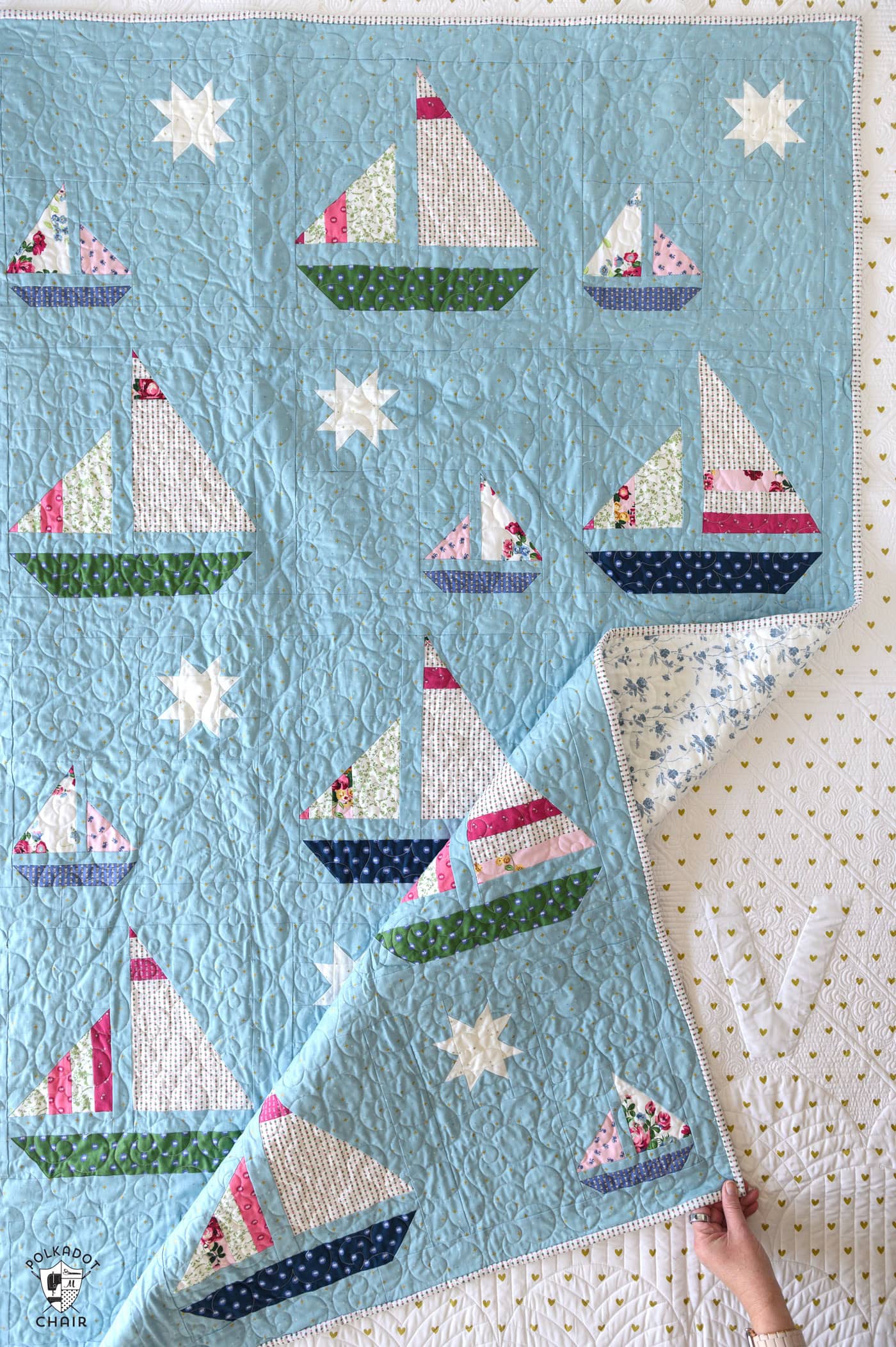 Blue quilt with white, red and green sailboat quilt blocks