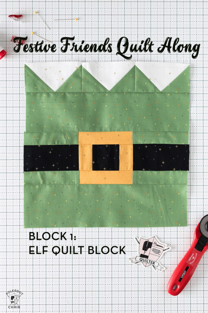Elf quilt block on white cutting mat with sewing notions