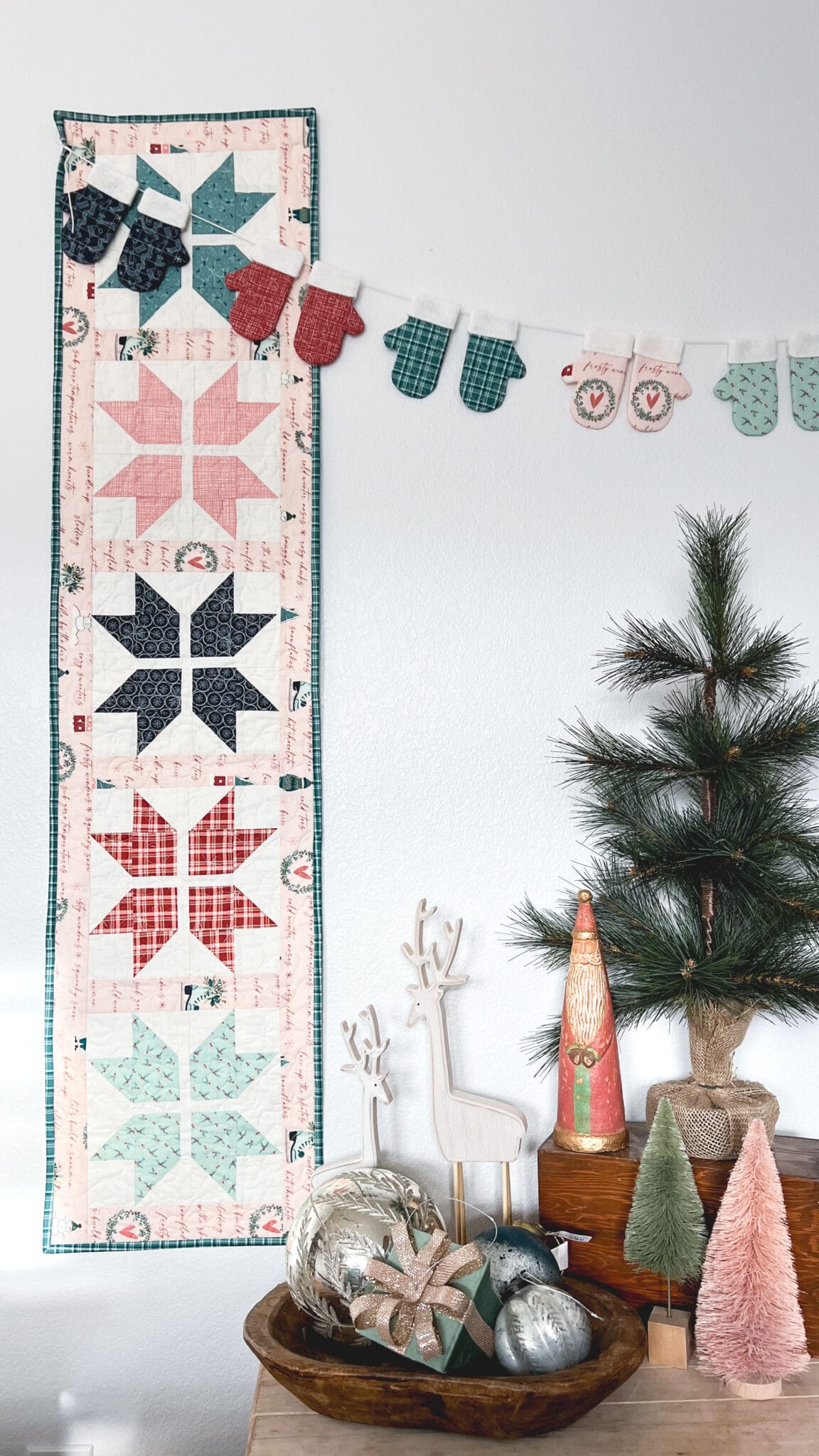 graphic pieced table runner hanging on wall next to winter home accessories