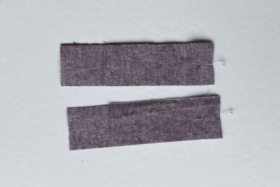 purple fabrics with quilt batting on white table